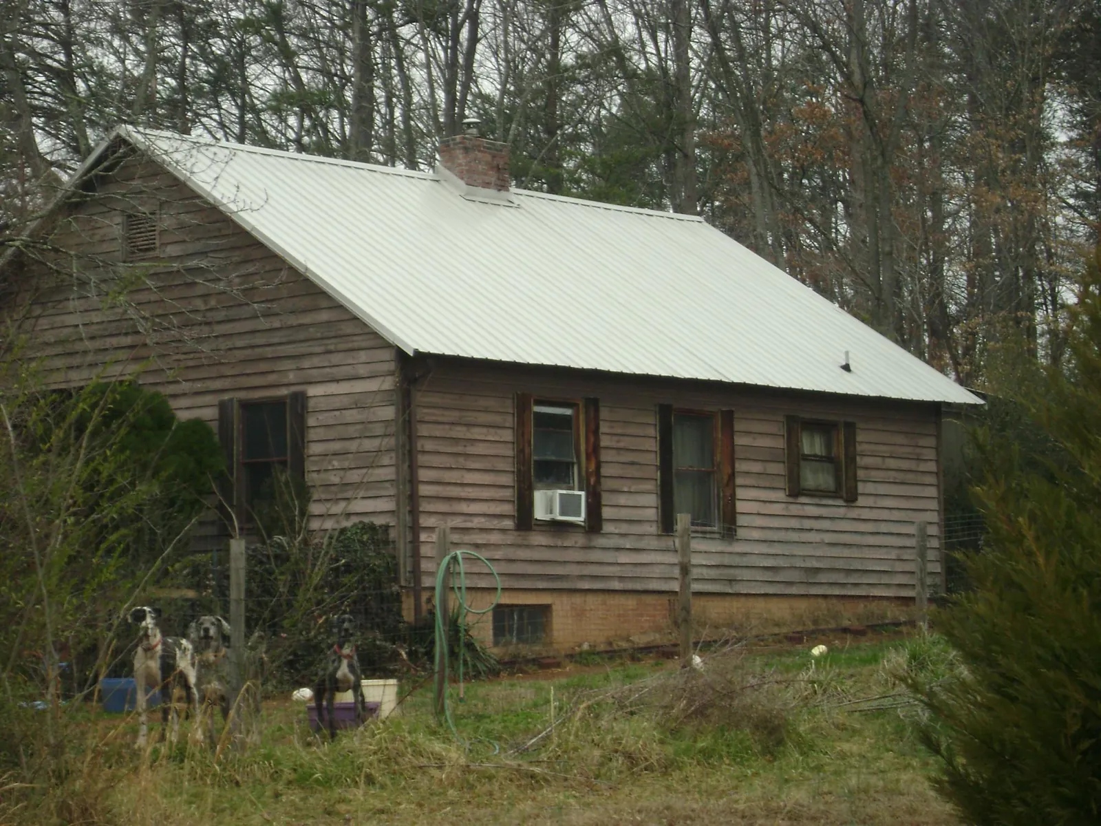 White metal roof on an old wood sided farmhouse, from a Metal Roof Installation job in Lovettsville